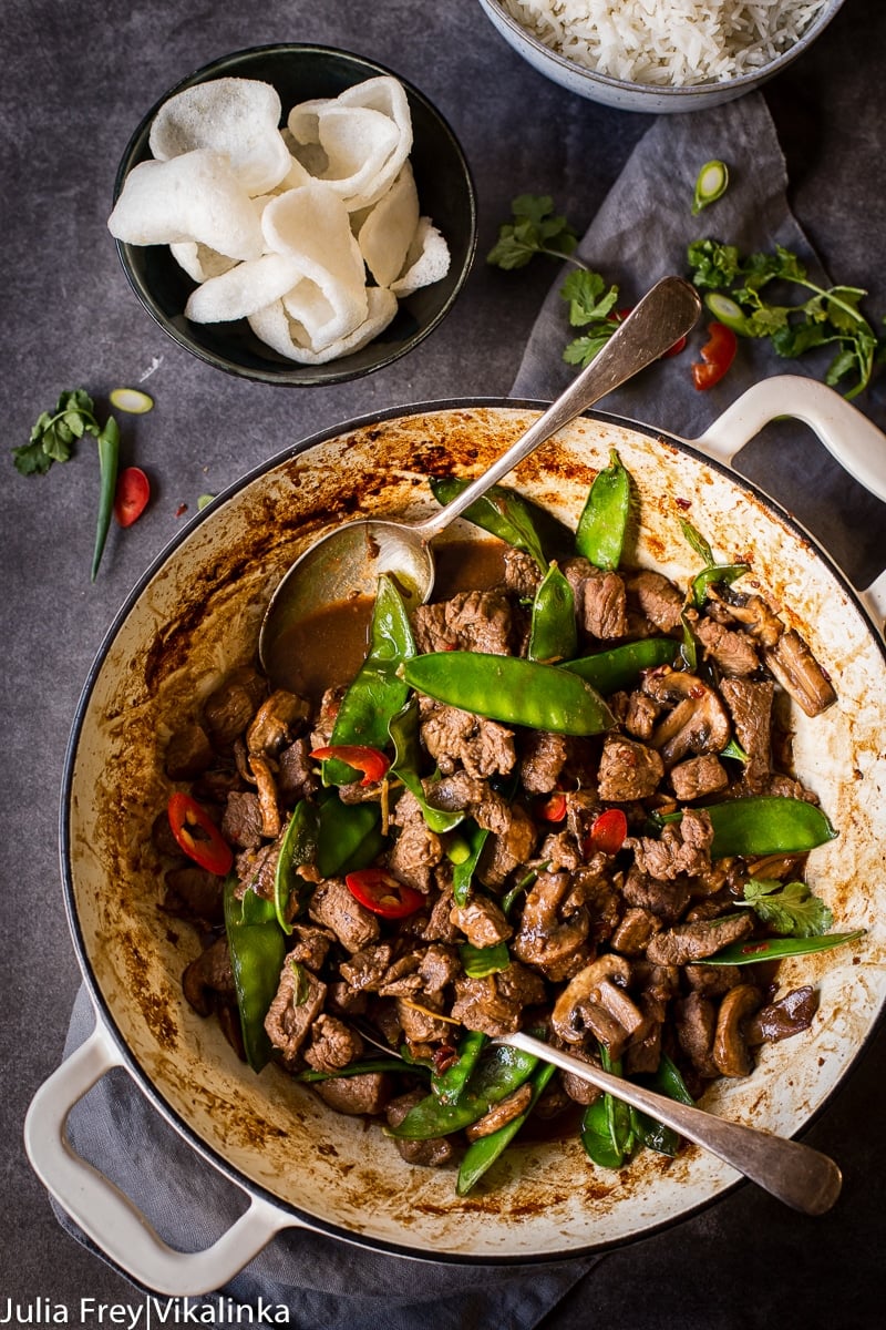 top down view Beef, Mushroom and Snow Pea Stir Fry, prawn crackers and rice