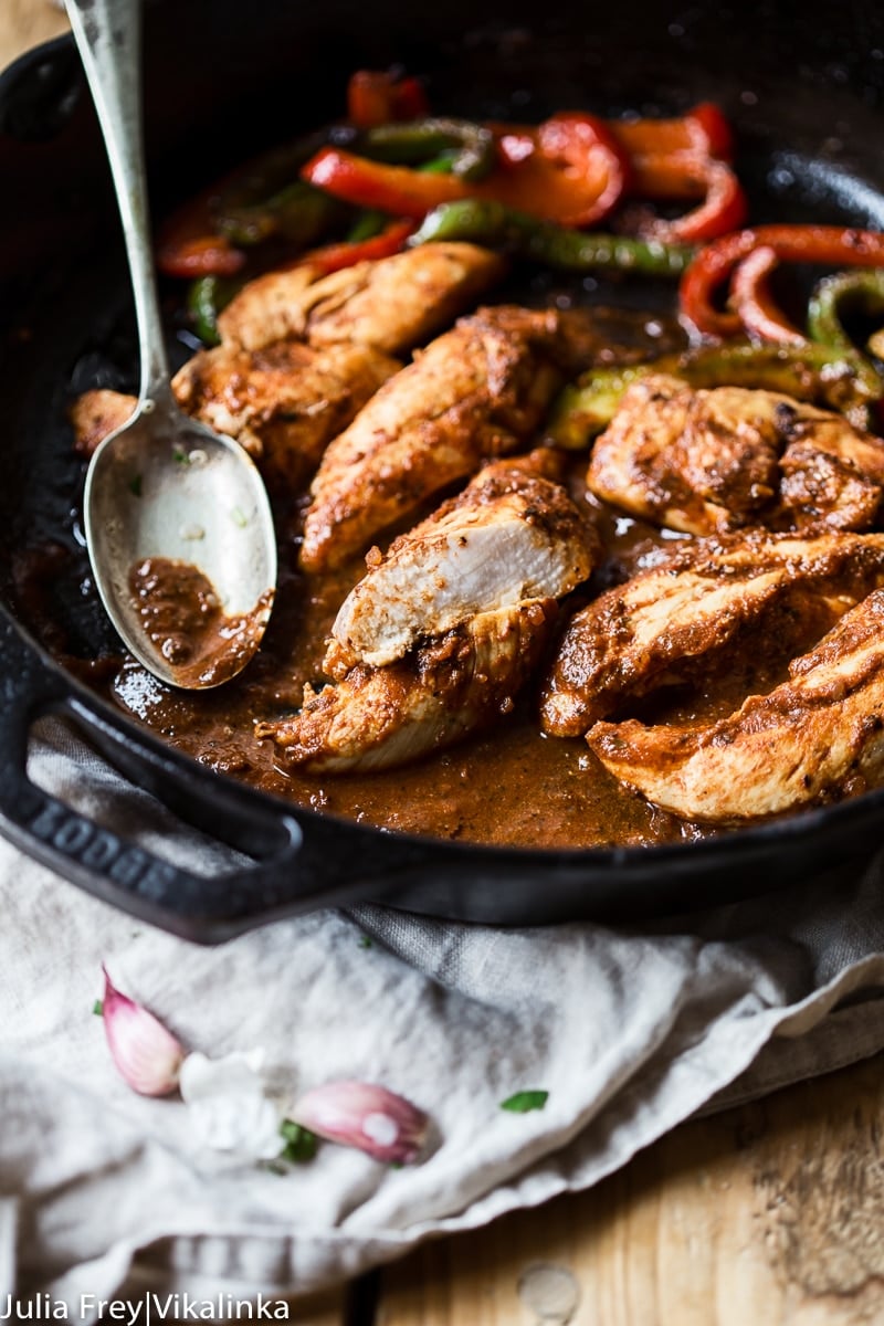 Cast iron pan with chicken and peppers