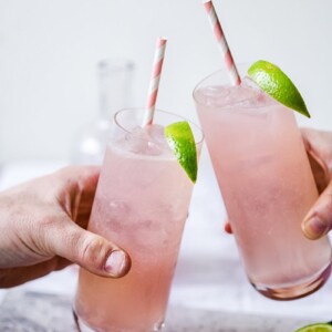 Two glasses of Rhubarb Moscow Mule brought together in toast