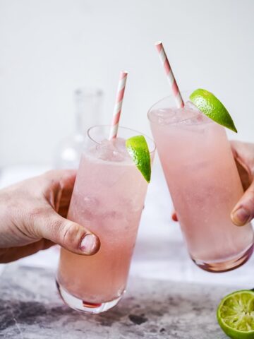 Two glasses of Rhubarb Moscow Mule brought together in toast