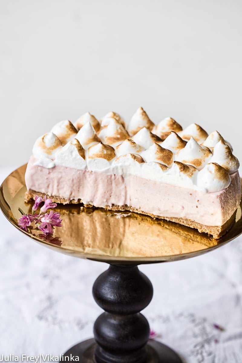 Side view of Strawberry Meringue Cheesecake with pieces removed