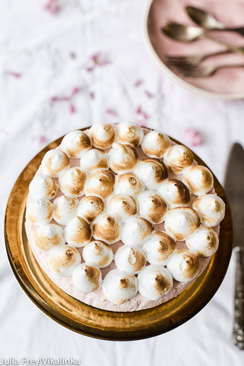 Top down view of cheesecake on a stand with cutlery below