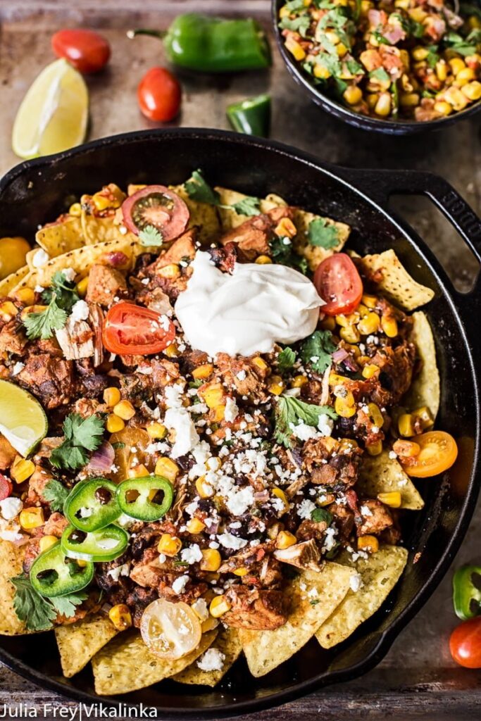 Chicken chilaquiles with warm corn salsa in a cast iron pan from the top down