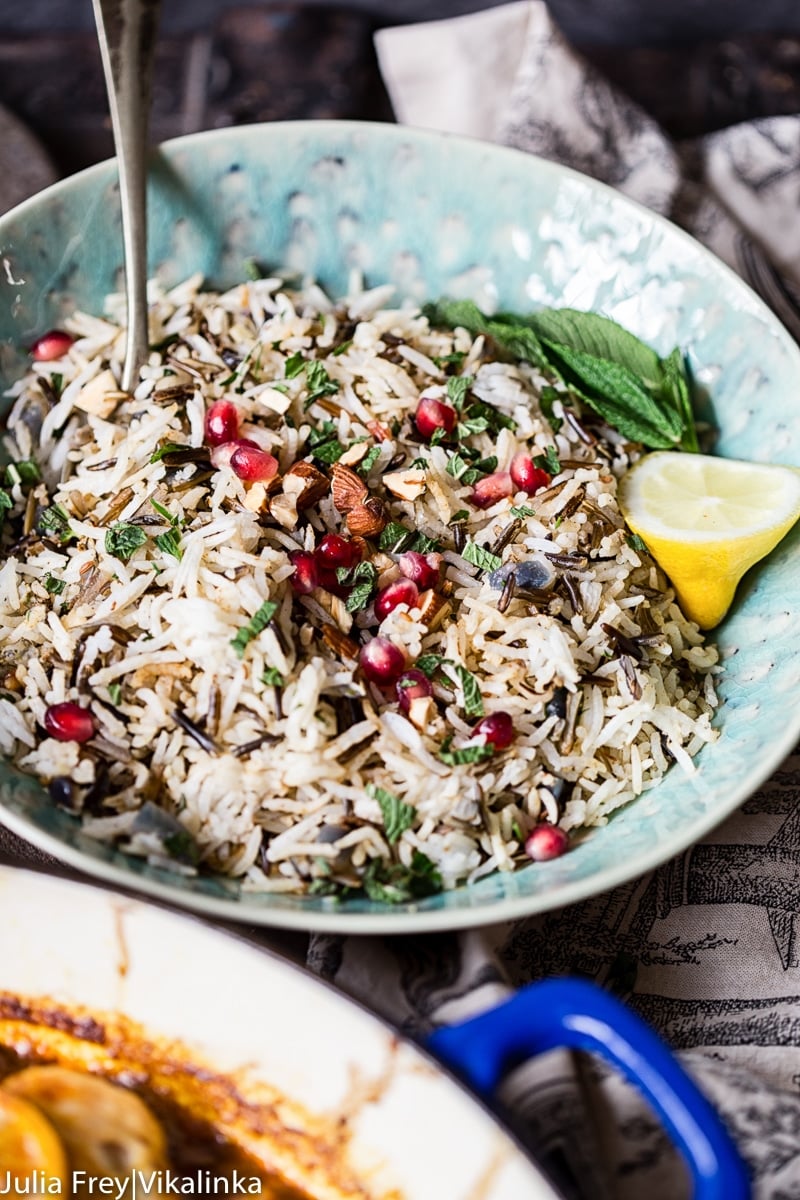 bowl of cooked and spiced rice with pomegranate seeds