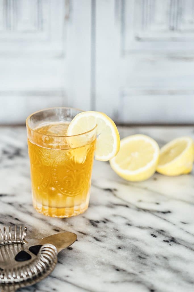 Close up of Earl Grey Gin and tonic in a glass with a lemon slice