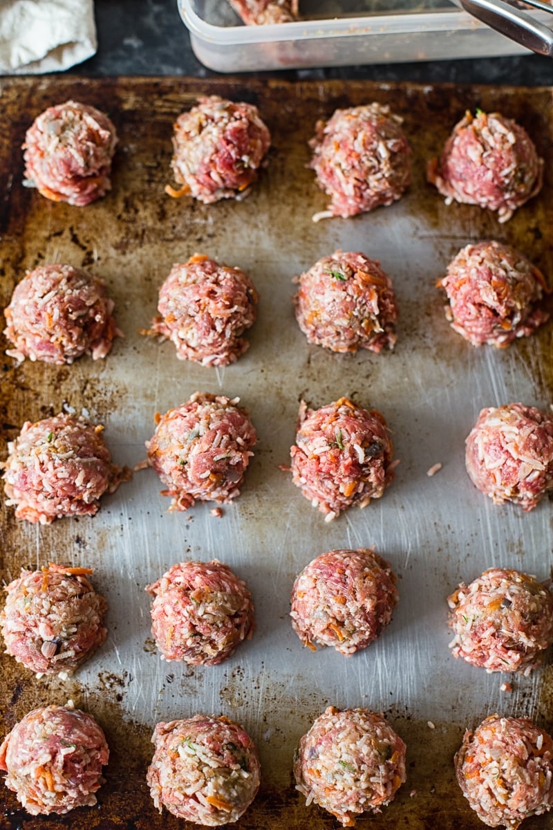 raw meatballs on a cookie sheet