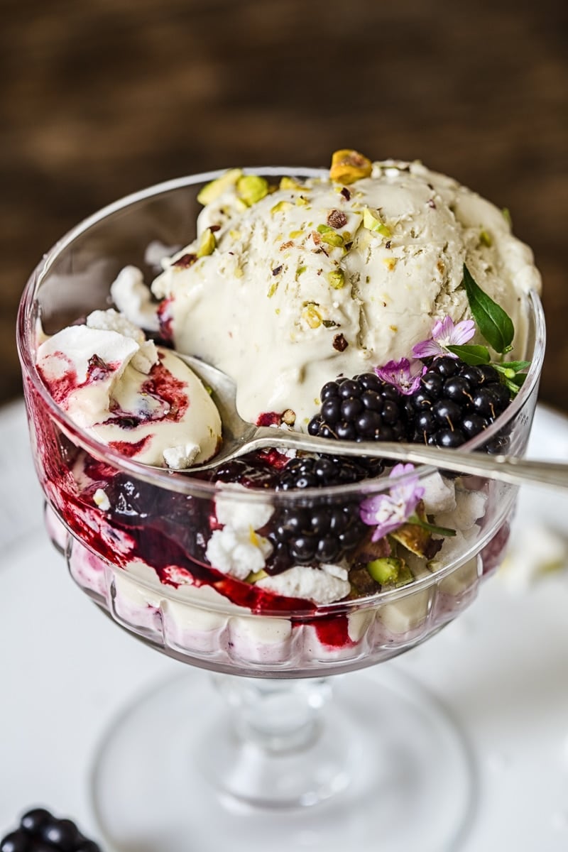 Dish of the Eton mess with a spoon and berries