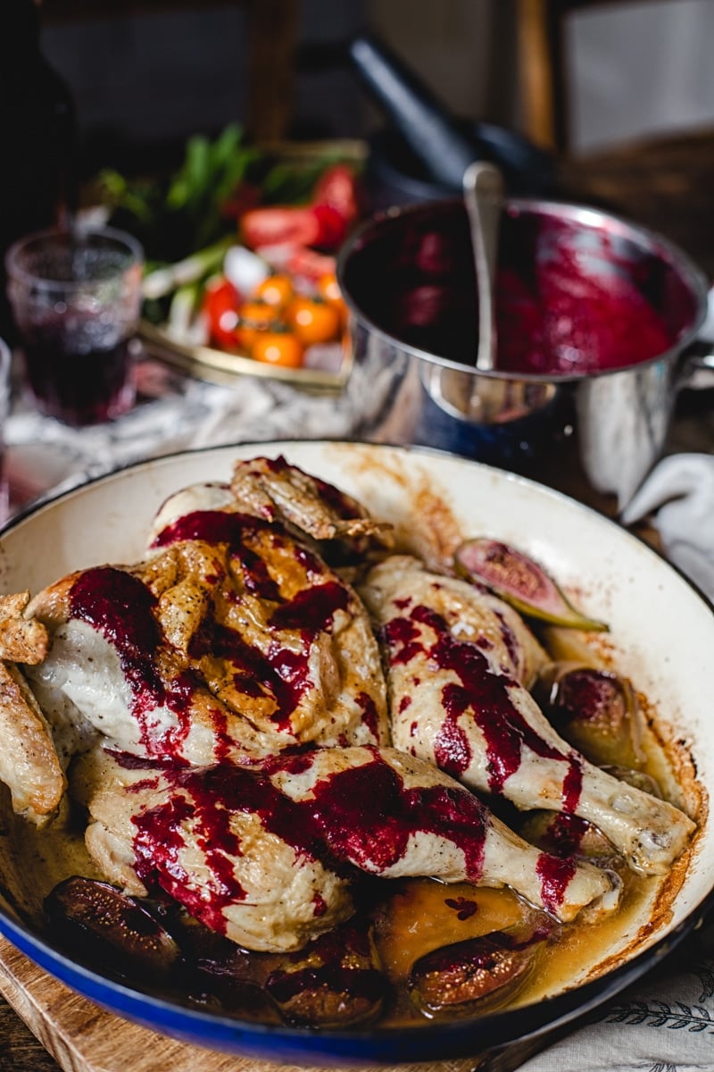 Chicken with blackberry sauce in a cooking pan