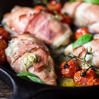 Side view of chicken parcels with cherry tomatoes