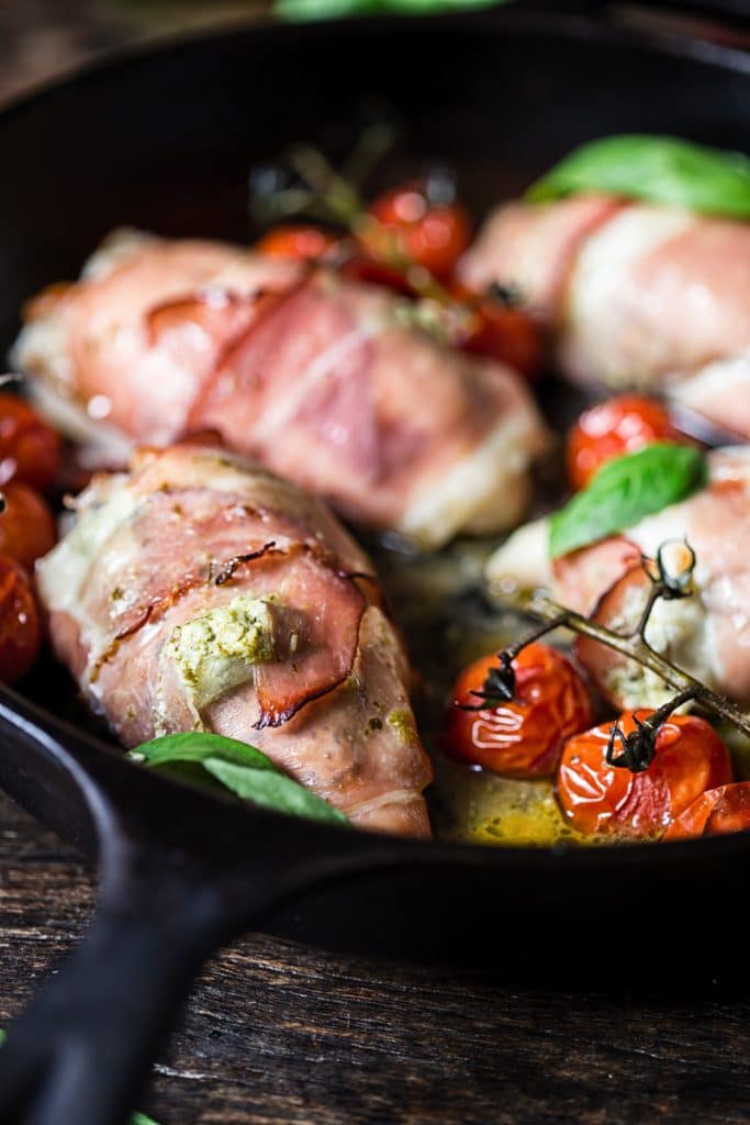 Side view of chicken parcels with cherry tomatoes