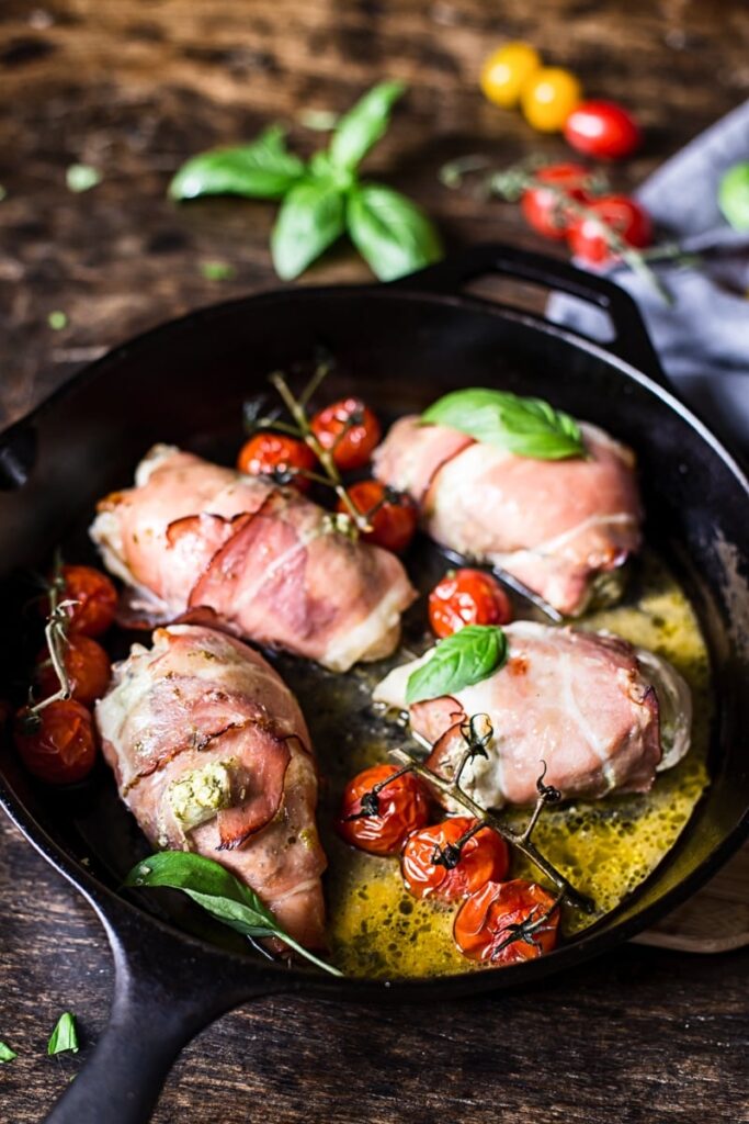 Chicken wrapped in prosciutto in a cast iron pan