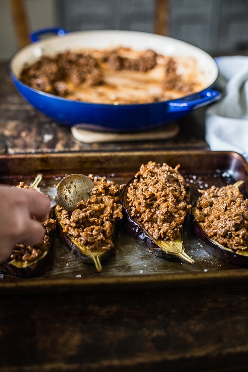 Eggplants being stuffed with harissa beef