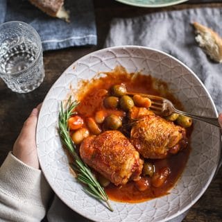 hand holding bowl of Italian Rosemary Chicken Stew