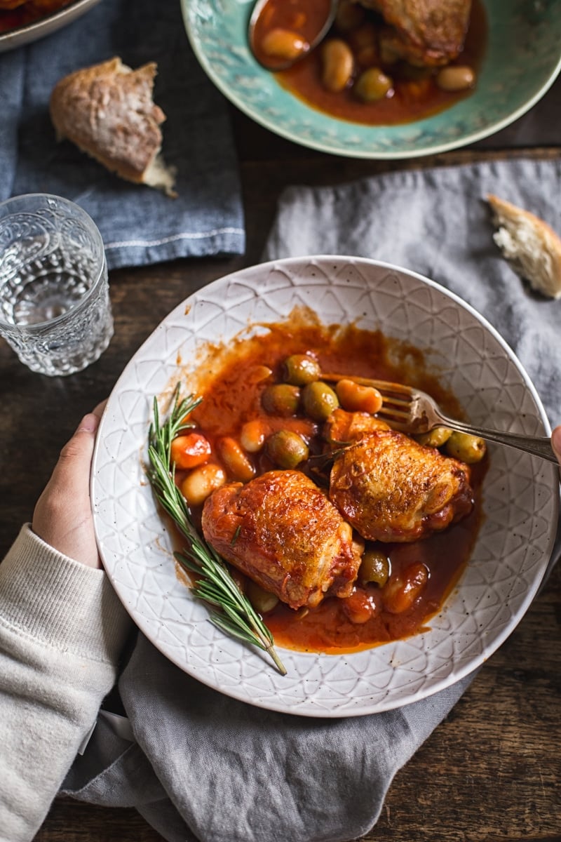 hand holding bowl of Italian Rosemary Chicken Stew