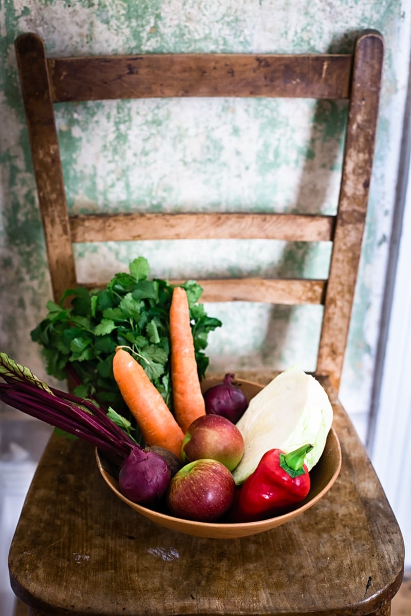 Bowl of vegetables on a wooden chair