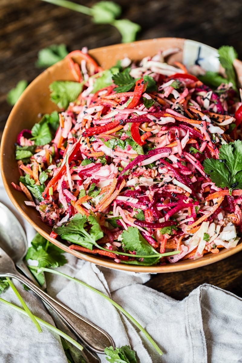 Bowl of rainbow slaw with lemon garlic tahini dressing