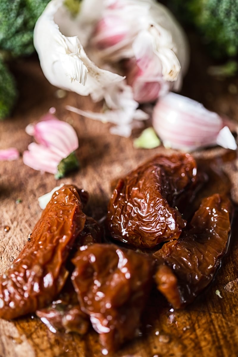 sun-dried tomatoes and garlic in the background