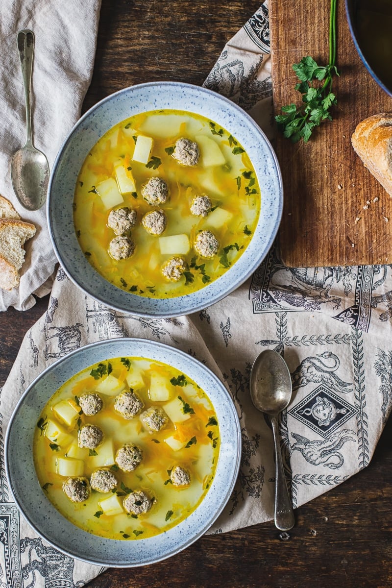 Top down view of two bowls of frikadeller meatball soup