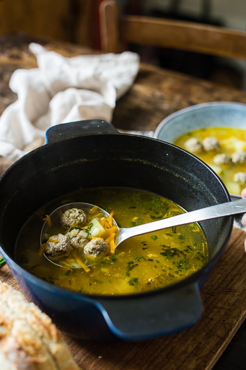 Pot on a wooden table with a ladle