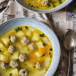 Two bowls of Russian Soup on a table seen from top down
