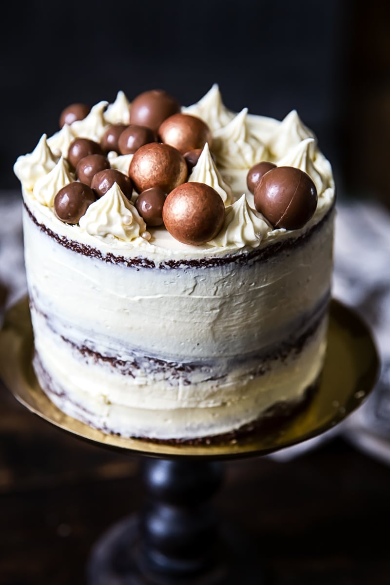 Black and white cake on a stand with decorations