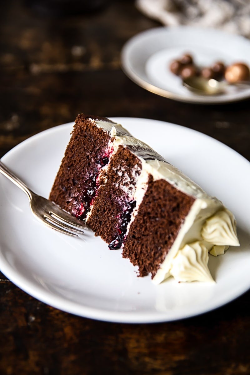 Piece of the black and white cake on a plate with fork