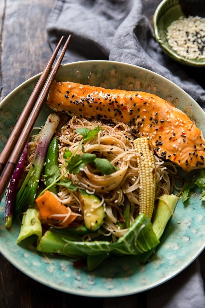 Bowl of fried noodles with vegetables and fish