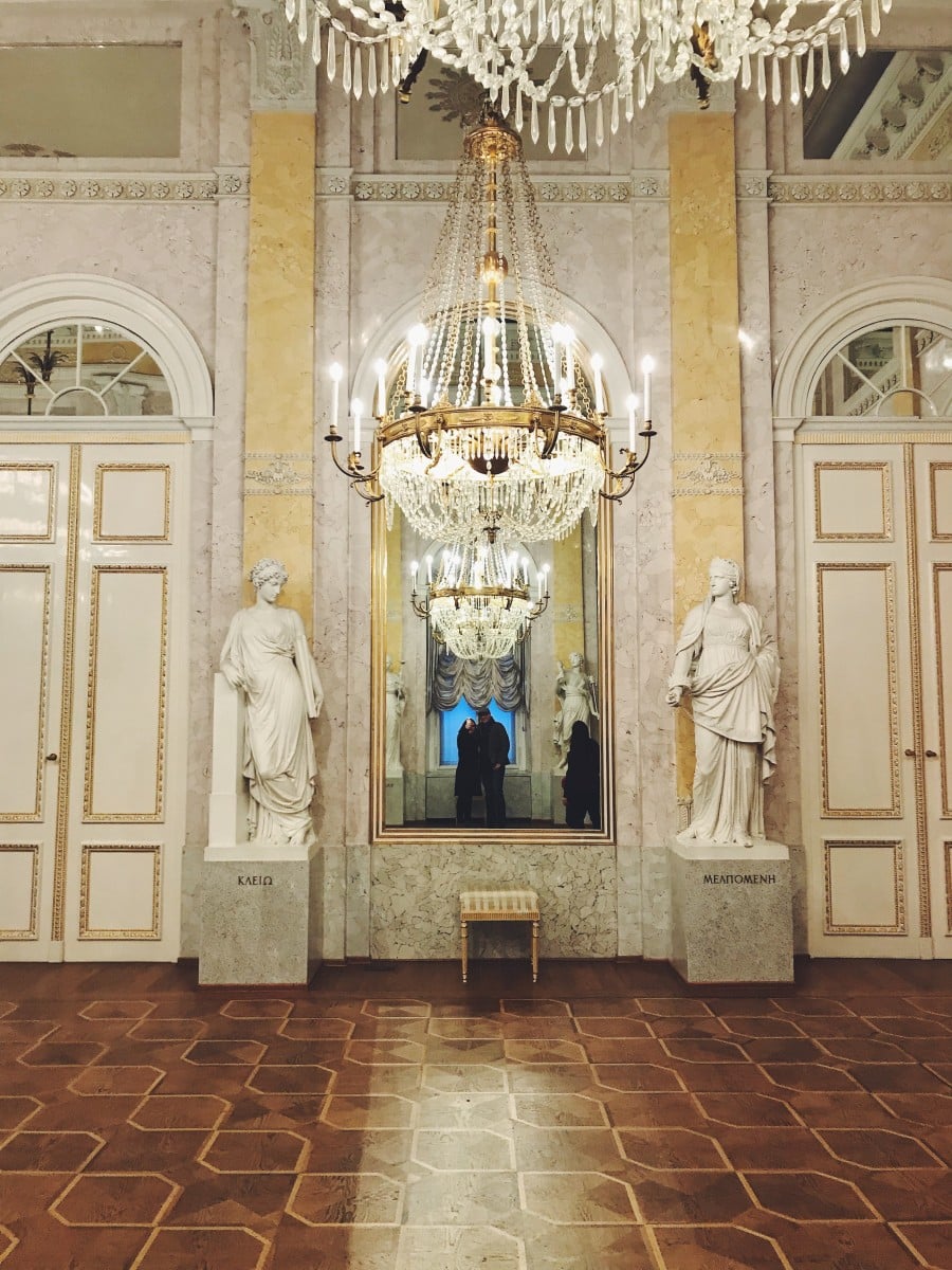 Chandeliers and statues in a palace hall