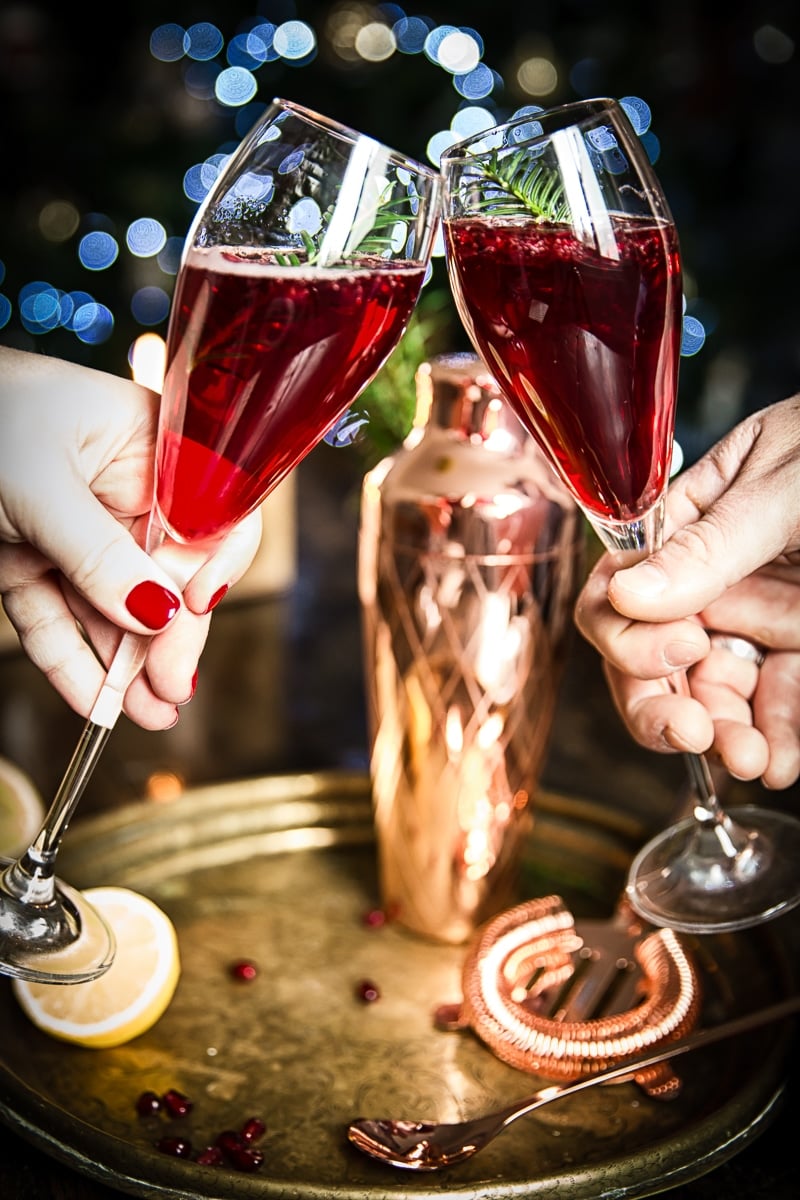 Two champagne glasses coming together in a toast