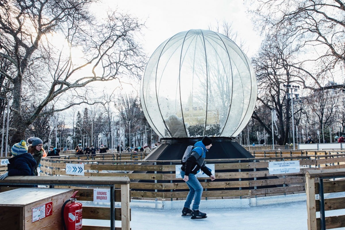 Skater and giant snowglobe at Rathousplatz Christmas Market