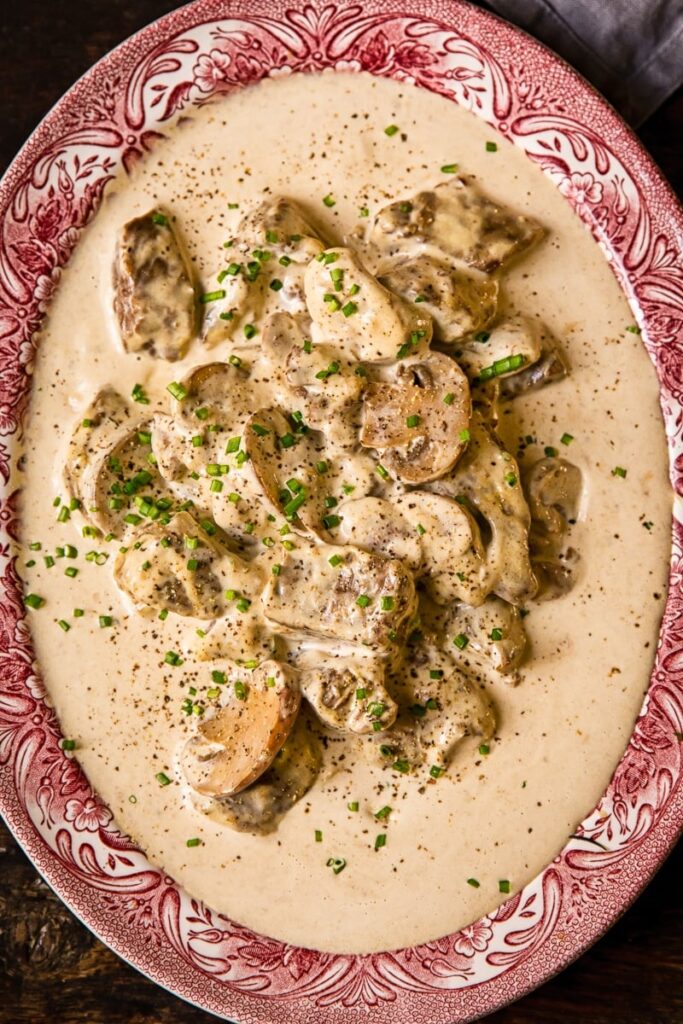 Close up of a plate with beef in creamy sauce