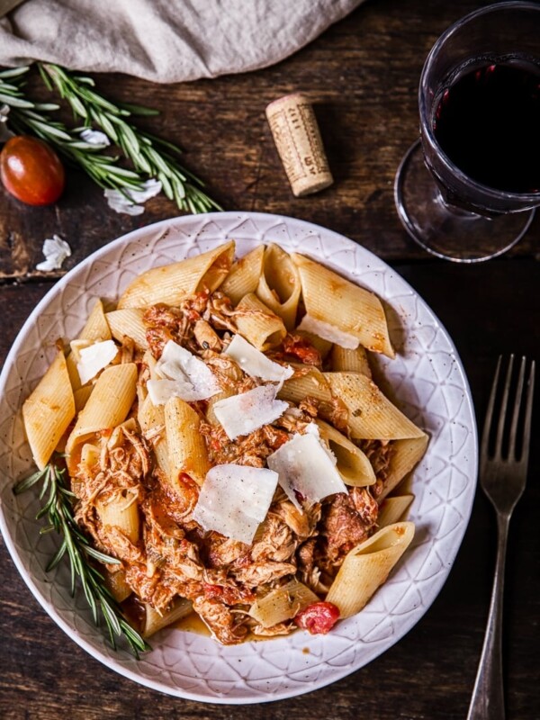 Top down view of the Venetian chicken ragu pata with a glass of wine and a fork