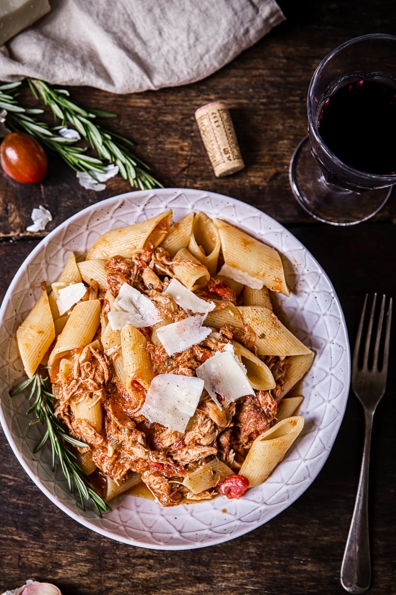 Top down view of the Venetian chicken ragu pata with a glass of wine and a fork