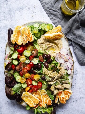 Top down view of Mediterranean Salad with Hummus and Fried Halloumi salad on a platter