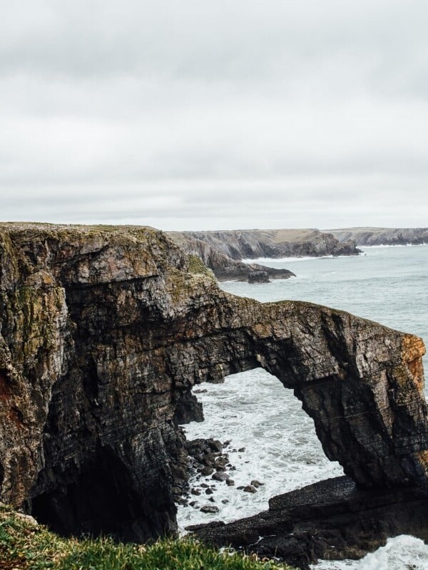 The Green Bridge of Wales over stormy sea
