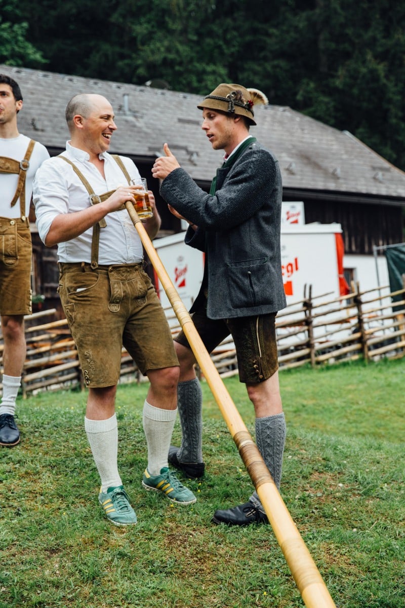 Brad learning the alphorn with help from Austrian in lederhosen