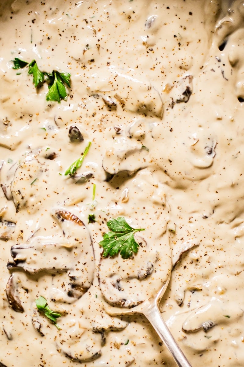 Close up of mushrooms and parsley in cognac sauce