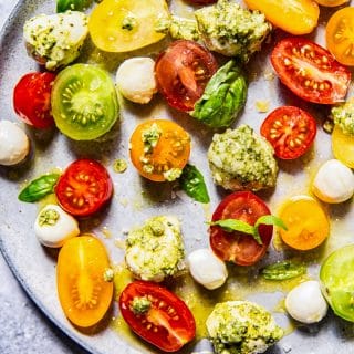 Close up of Basil Pesto Caprese Salad on a grey plate