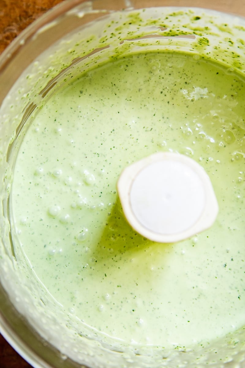 Close up of food processor with green goddess dressing