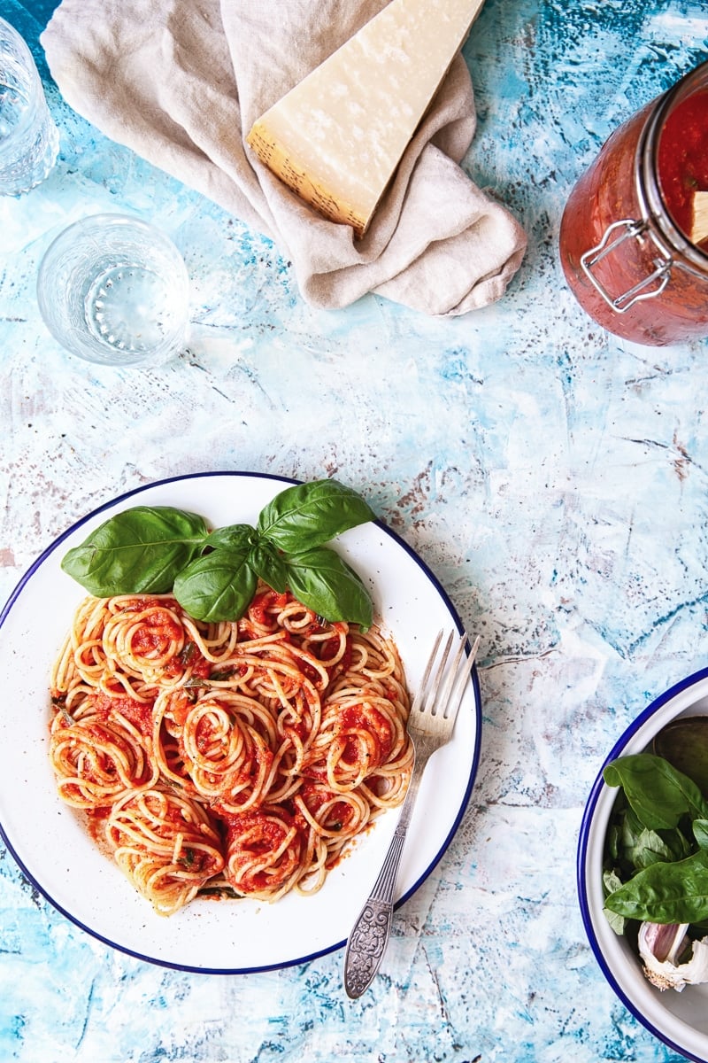 White plate of pasta on a blue background