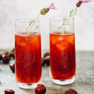 cherry long island iced tea in glasses with flower garnish