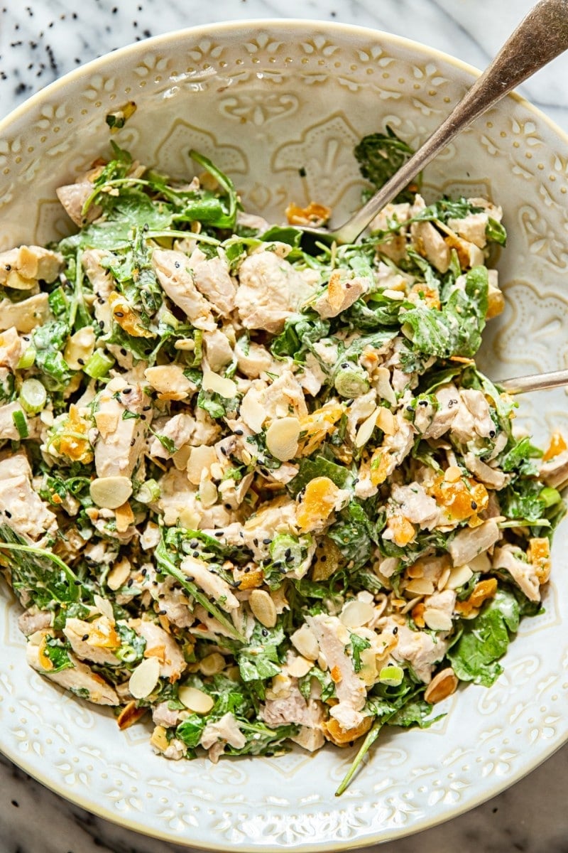 A close up of the salad in a wide bowl with a serving spoon