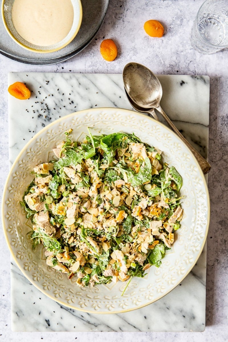 top down view of the salad next to spoons and apricots