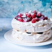 Pavlova on a plate with berries on top
