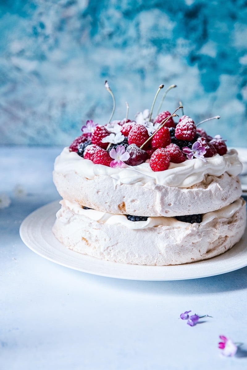 Pavlova on a plate with berries on top