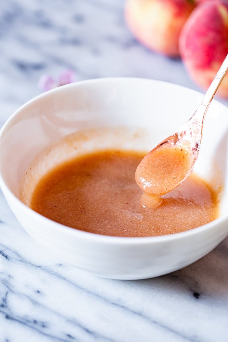 Bowl and spoon with elderflower peach puree