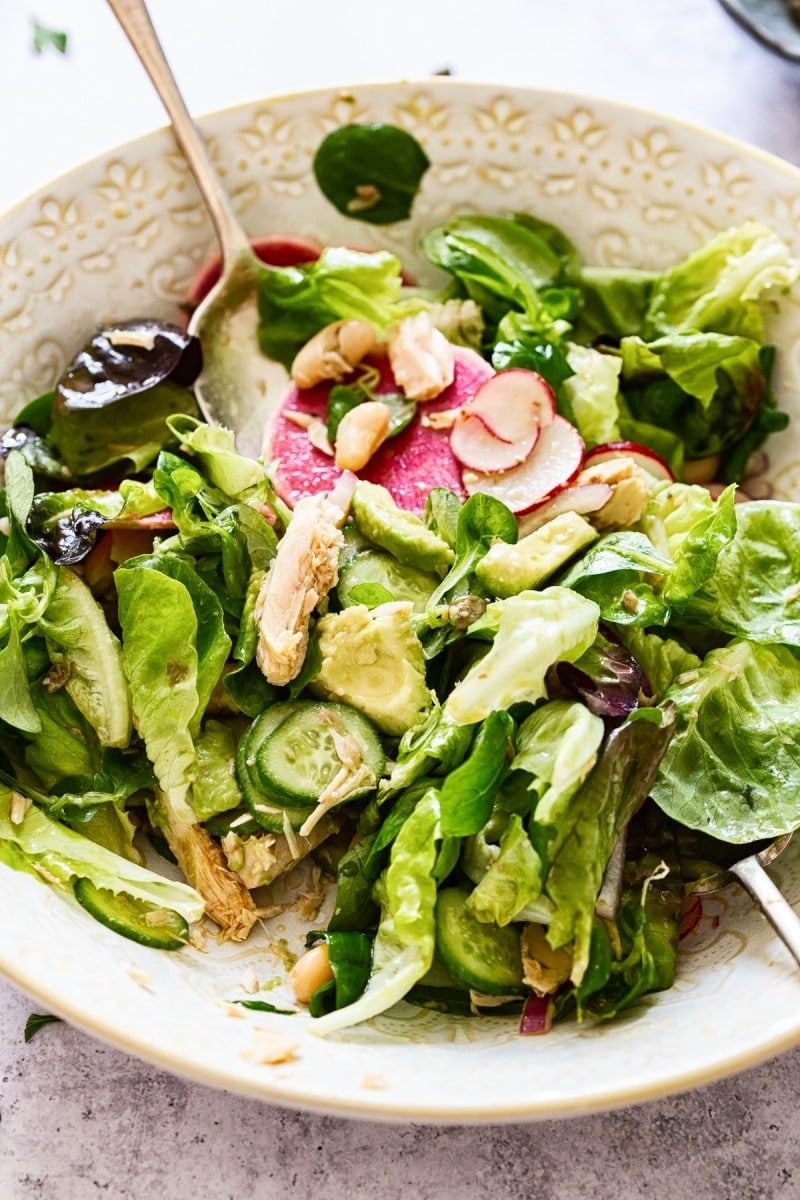 Bowl with lettuce and radishes with a spoon