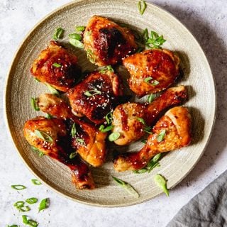 top down view of chicken thighs and legs sprinkled with green onions