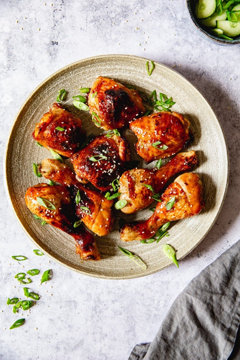 top down view of chicken thighs and legs sprinkled with green onions