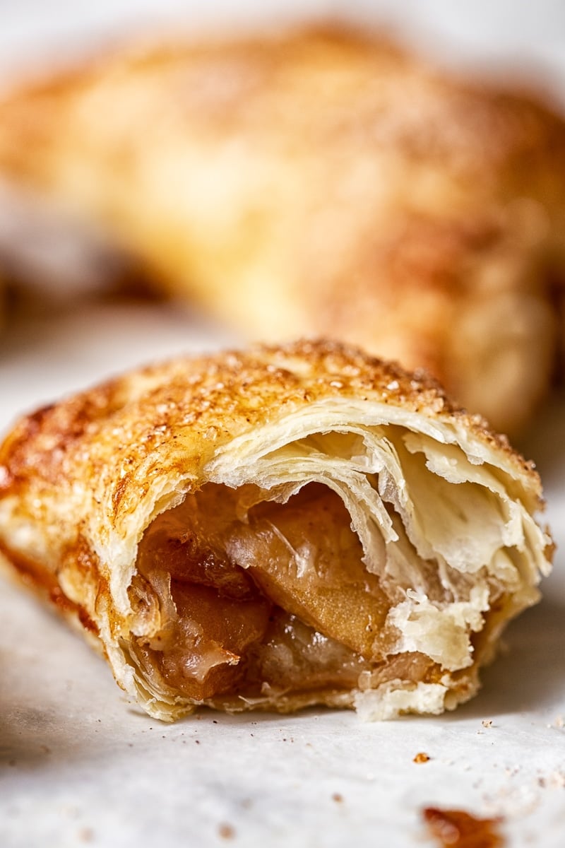 close up of an apple turnover opened by a bite